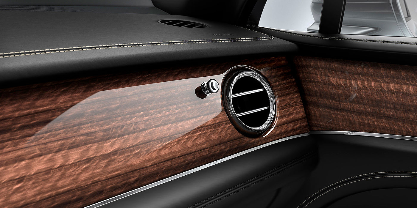Bentley Antwerp Bentley Bentayga front interior Crown Cut Walnut veneer and chrome air vent.